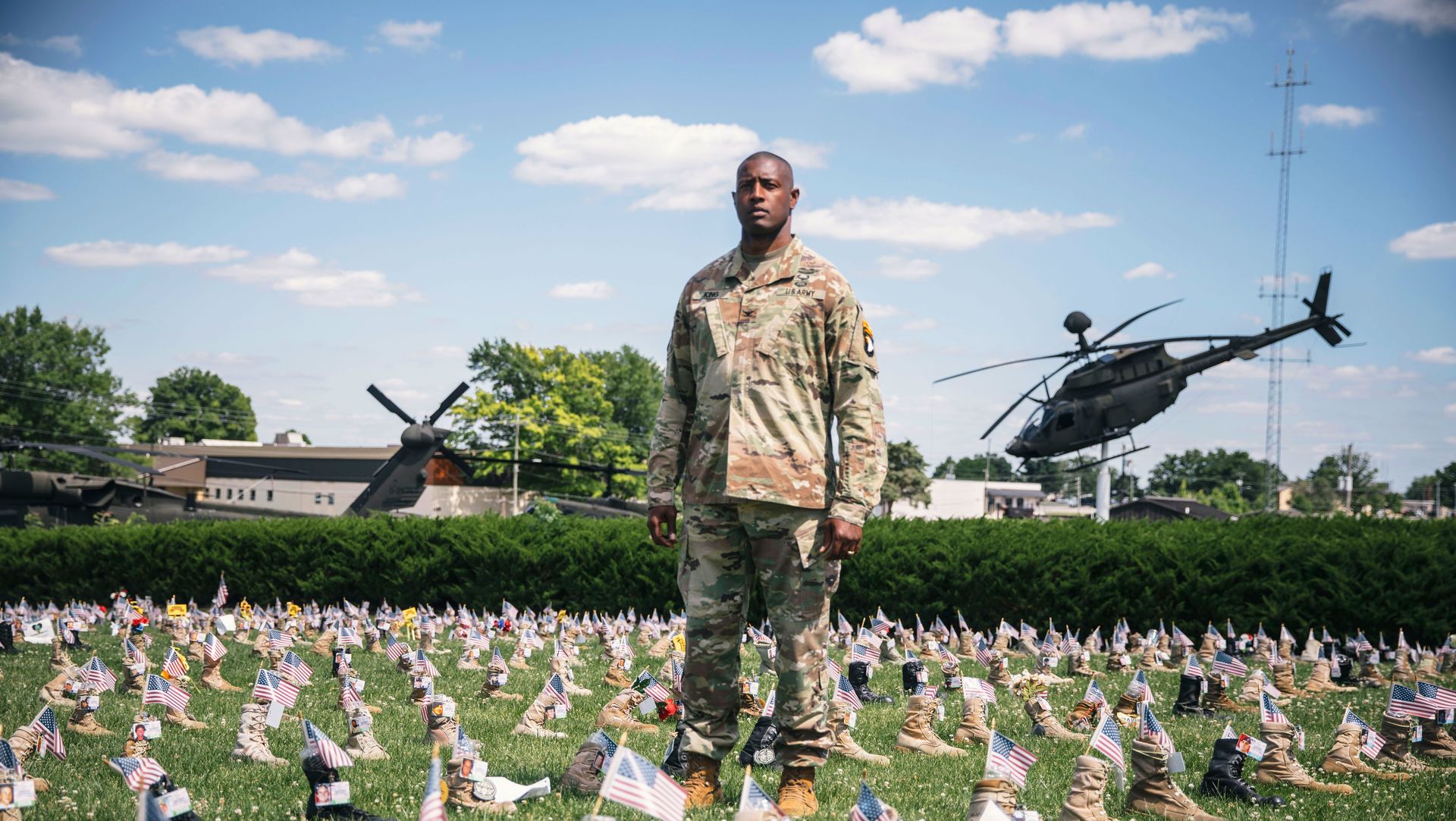 soldier standing among many small flags