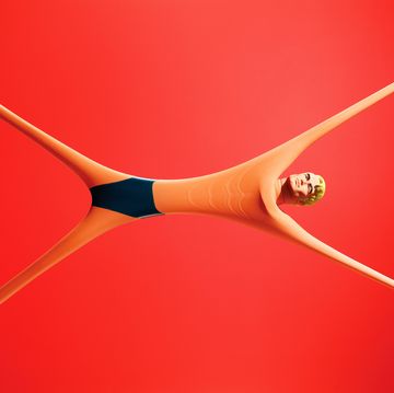stretchy toy pulled in all directions on red background