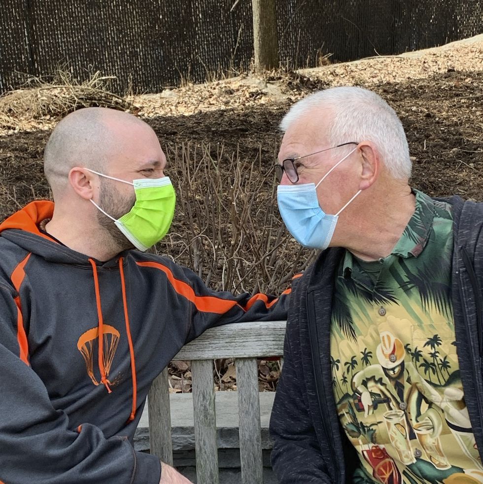 Elderly Man With Protective Mask And Gloves Talking To The