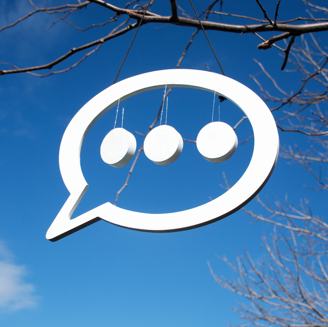 text bubble with dots against blue sky