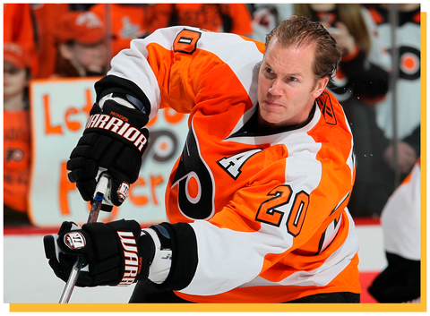chris pronger in uniform and holding a hockey stick