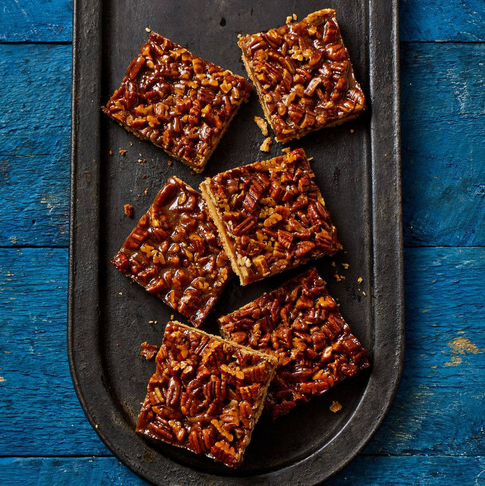 pecan pie bars on black metal tray