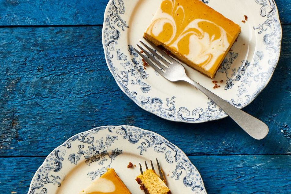 pumpkin cheesecake bars on blue and white plates