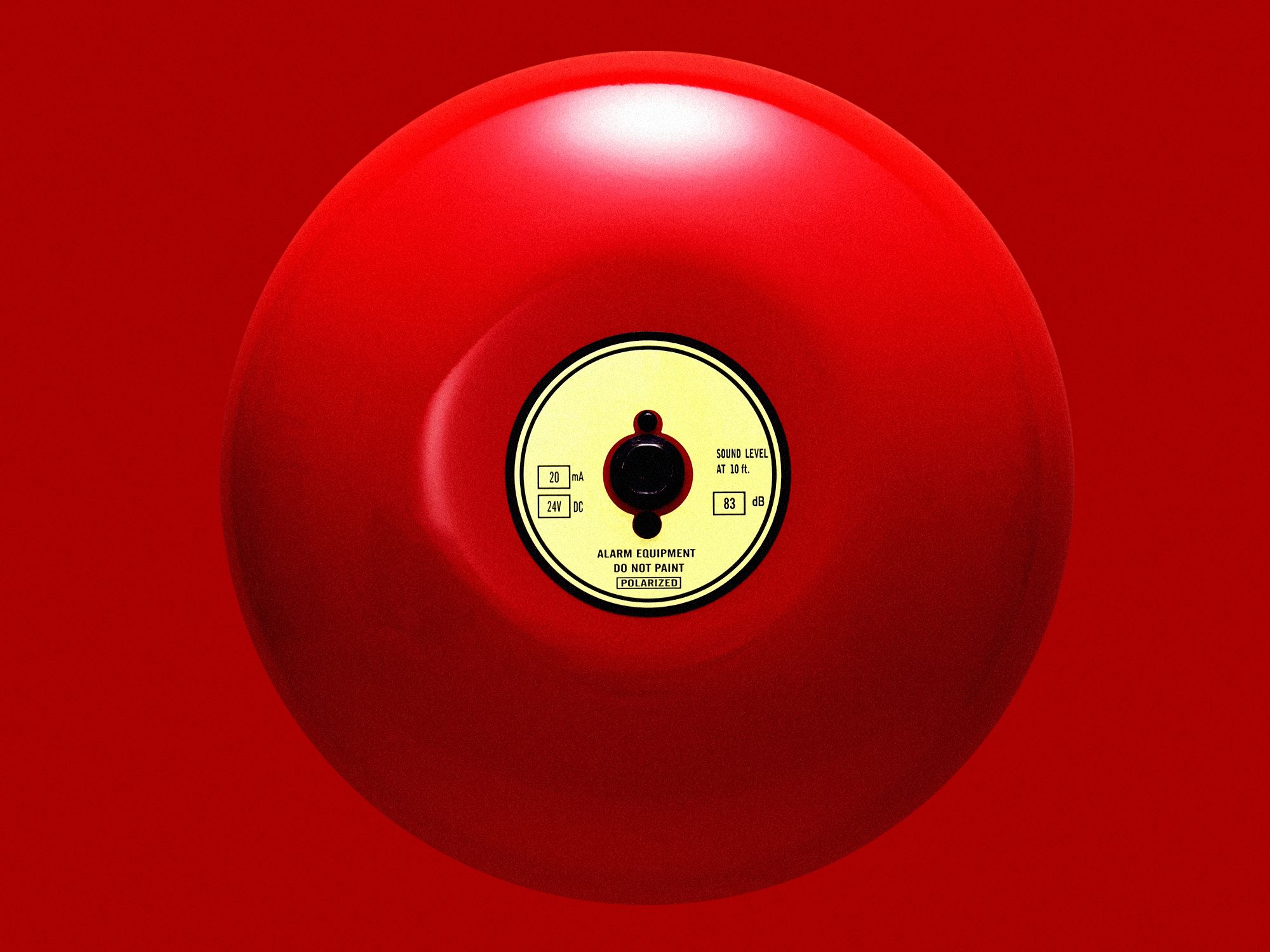 alarm bell on red background