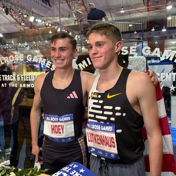 two male athletes posing at a track event two male athletes posing at a track event