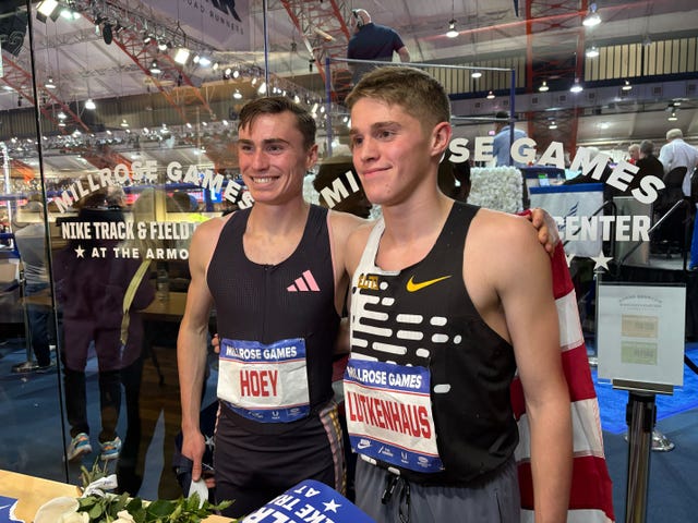 two male athletes posing at a track event
