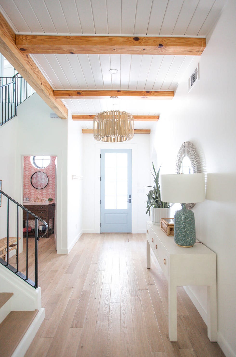 entryway with staircase and powder room under the stairs