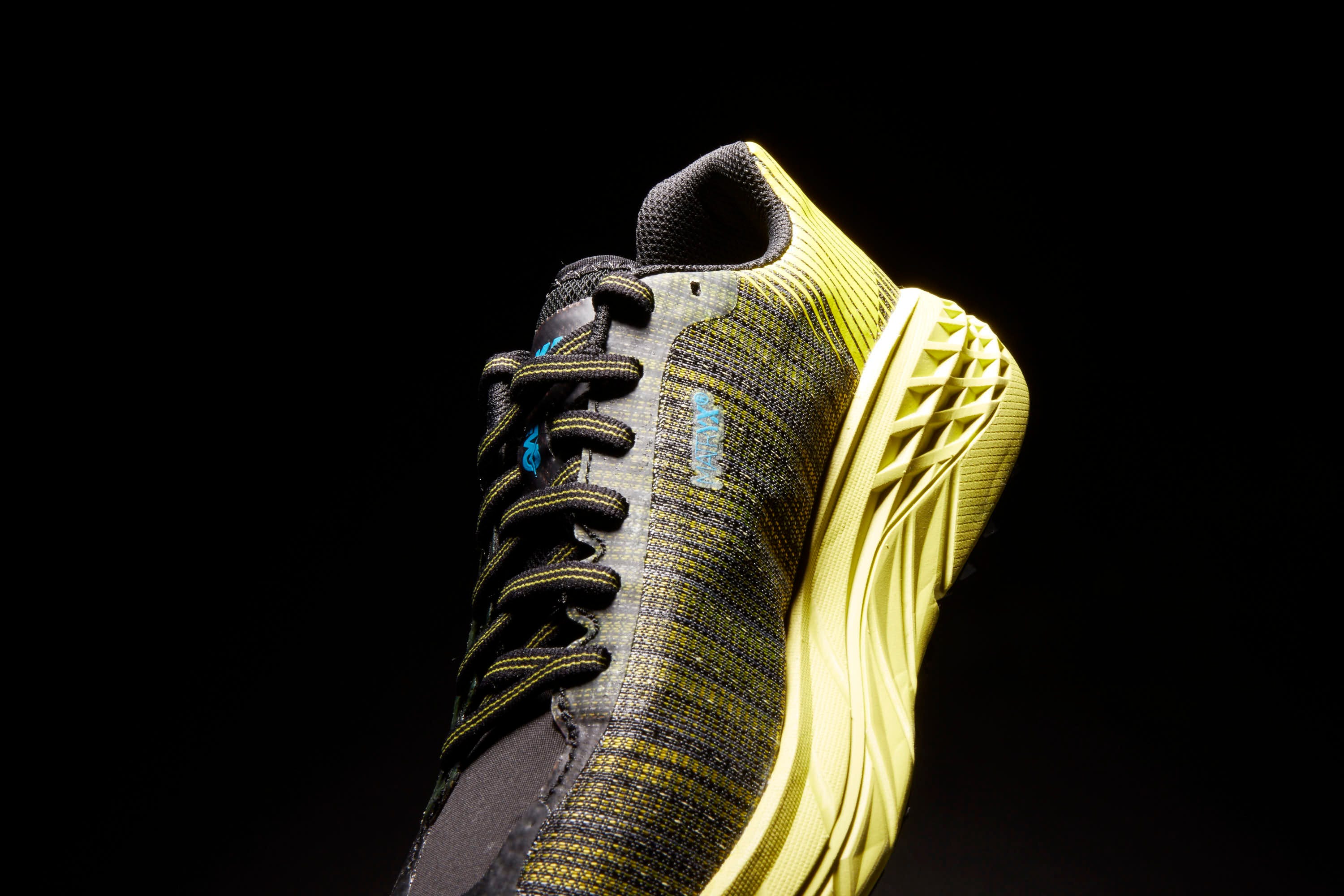Black, Footwear, Yellow, Shoe, Athletic shoe, Sculpture, Still life photography, Metal, 