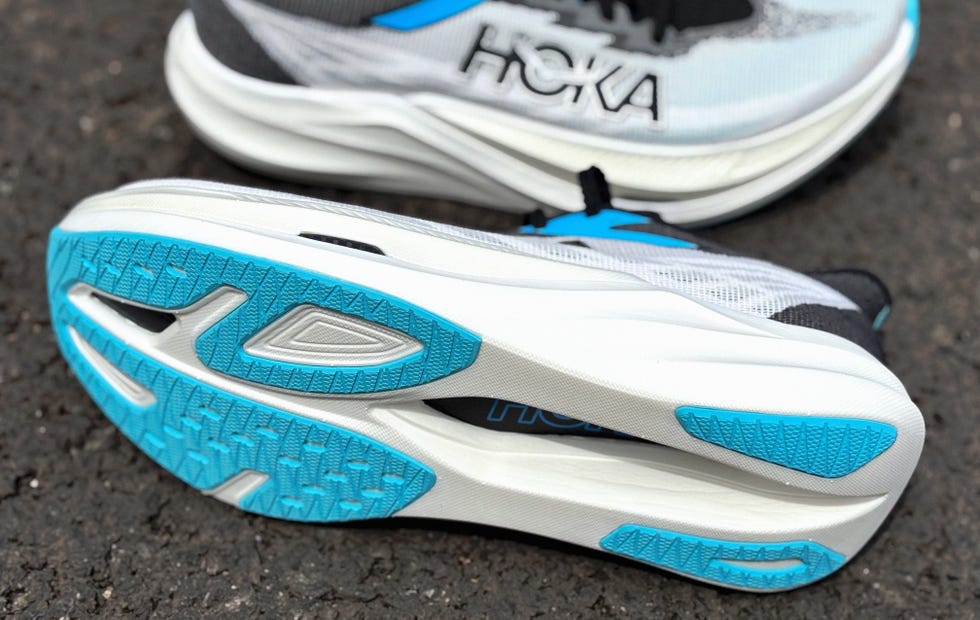 a running shoe on its side showing a blue and white outsole
