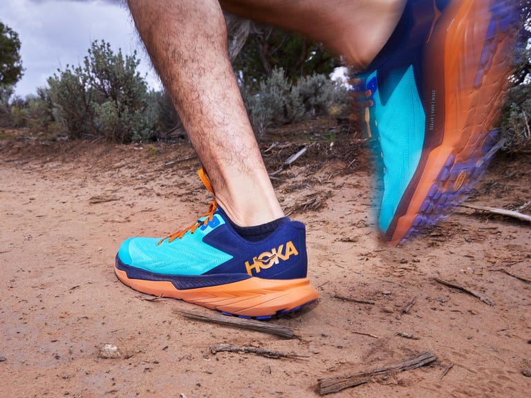 hoka zinal worn by a male runner on a trail