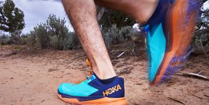 hoka sent zinal worn by a male runner on a trail