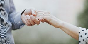 Holding hands with engagement ring, surprise proposal
