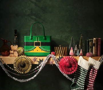 christmasthemed decorative display with a prominent green handbag