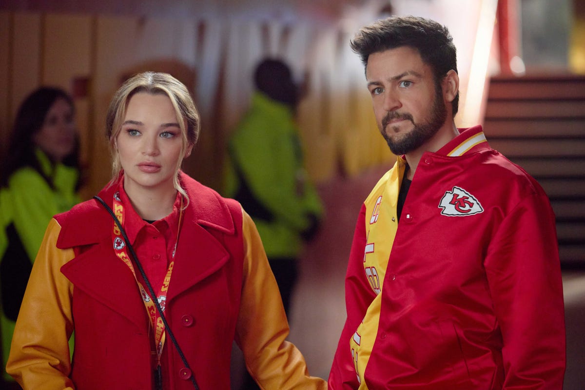Two individuals wearing colorful attire in a sports venue