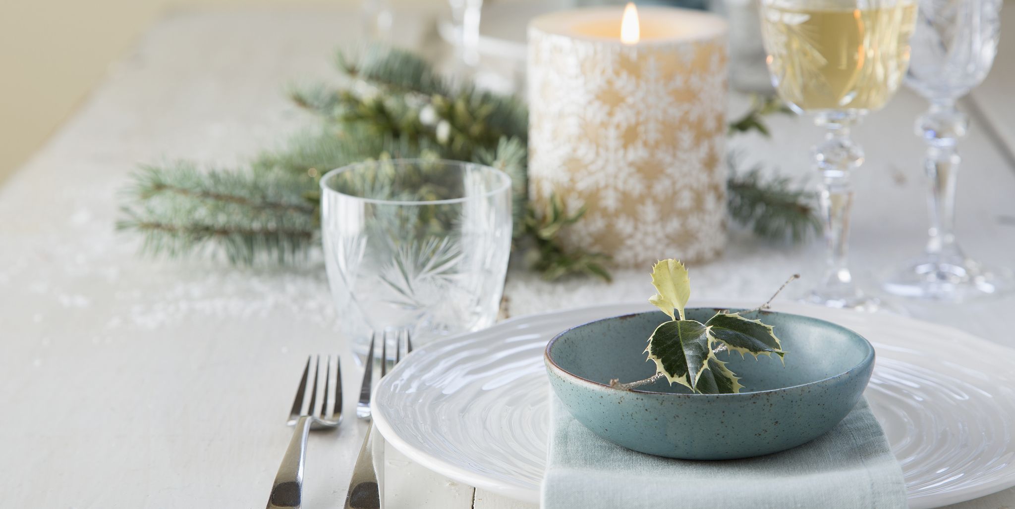 Holly and place setting on Christmas table