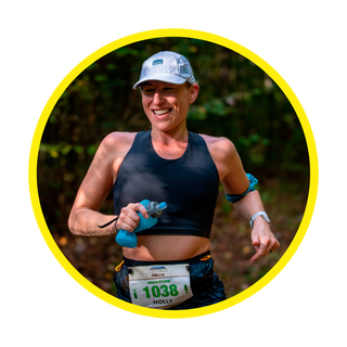 runner in race with hat holding water bottle