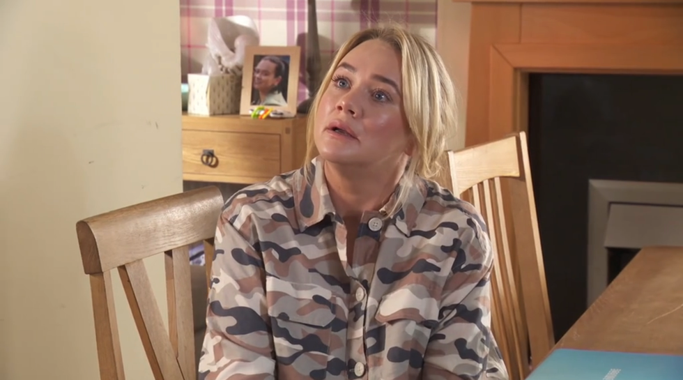 leela lomax in hollyoaks, a woman sits at a dining table