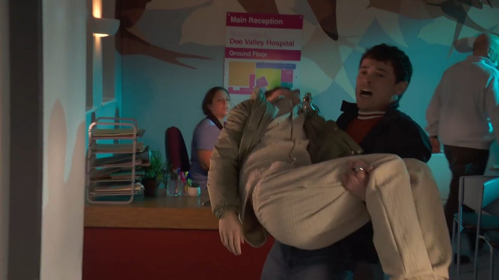 hollyoaks, rex carrying lucas into the hospital foyer