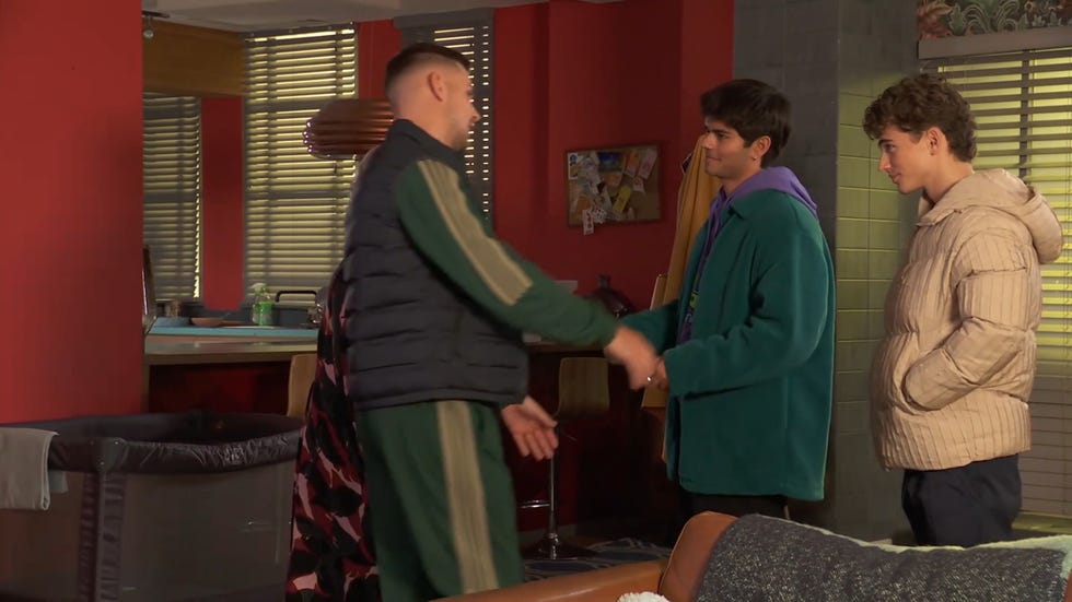 hollyoaks ste going in to hug dillon, with lucas next to them and misbah in the background