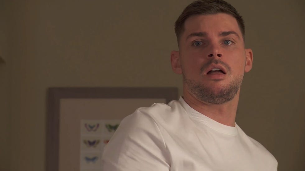 hollyoaks, ste hay in a white t shirt looking shocked in a march 2025 episode