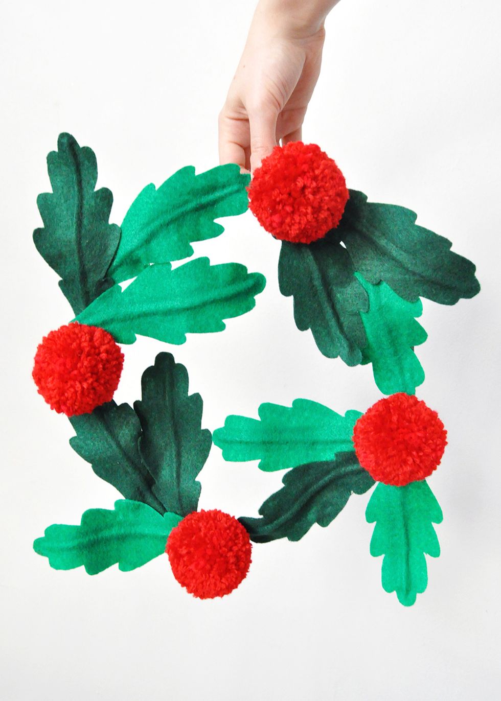 xmas wreath with pine cones, red and gold colored toys