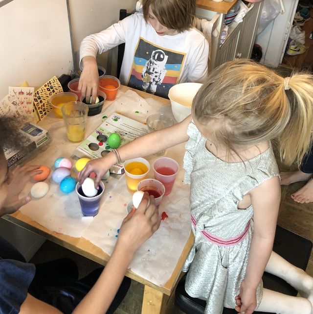 two kids dying easter eggs