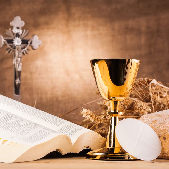 chalice bible cross bread eucharist on table