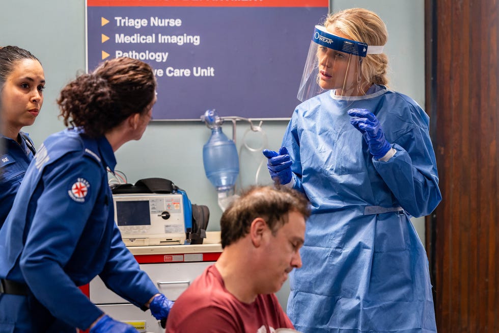 Bree Cameron watches as another patient is brought into the hospital in Home and Away bree cameron watches as another patient is brought into the hospital in home and away
