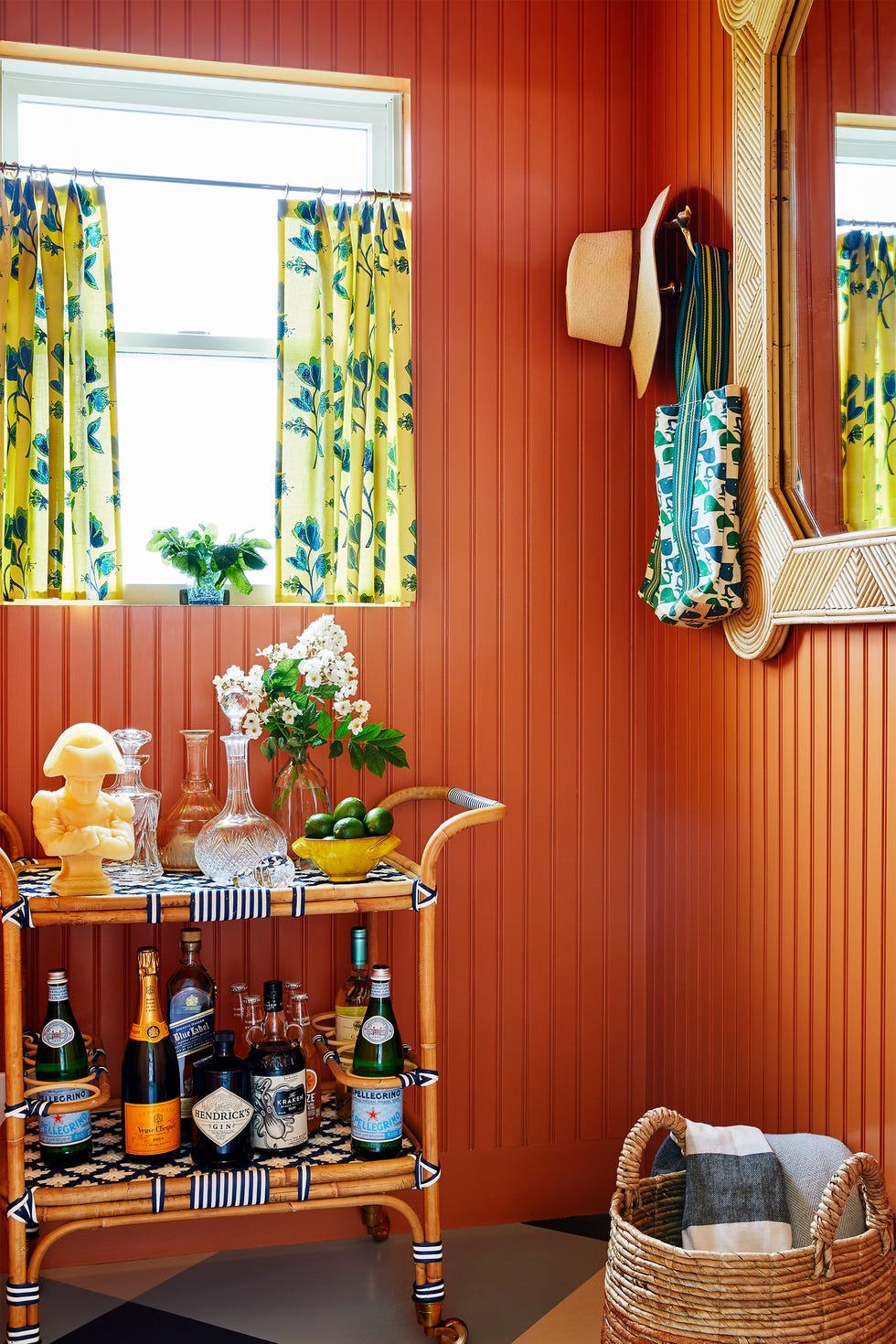 small orange home bar with tropical bar cart