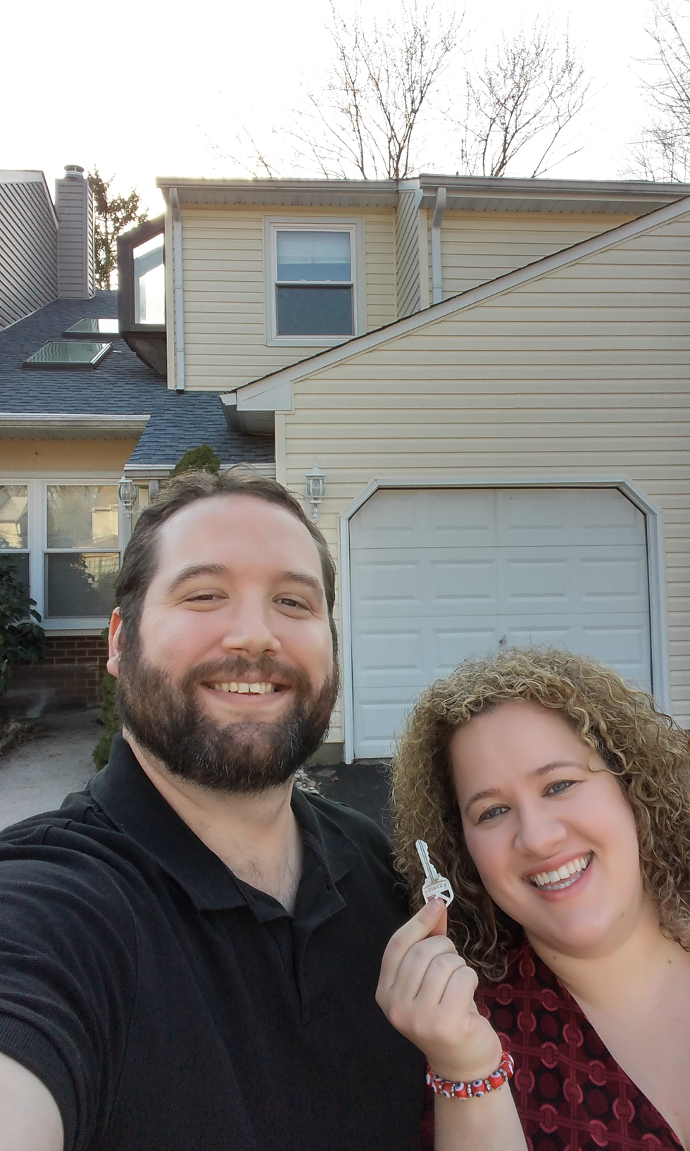 author in front of her purchased home