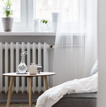 Home interior with small table in front radiator