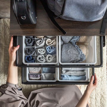 woman opening organized drawers in closet