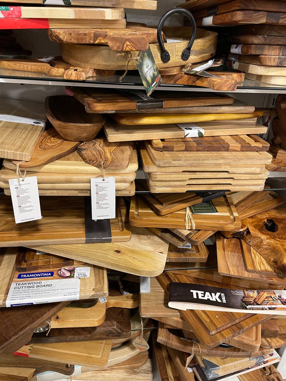 collection of wooden cutting boards and serving platters displayed at a homegoods store