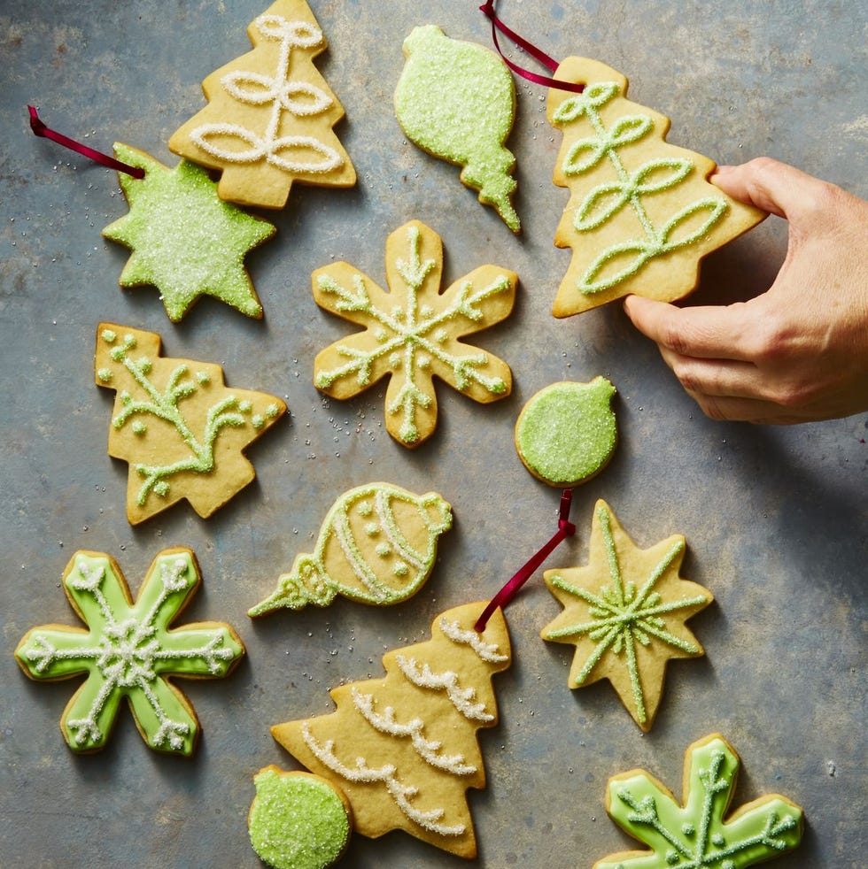 a group of christmas sugar cookies with trees, snowflakes and ornaments