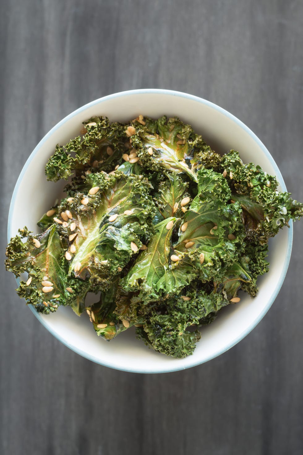 homemade curly kale chips sprinkled with flax seeds