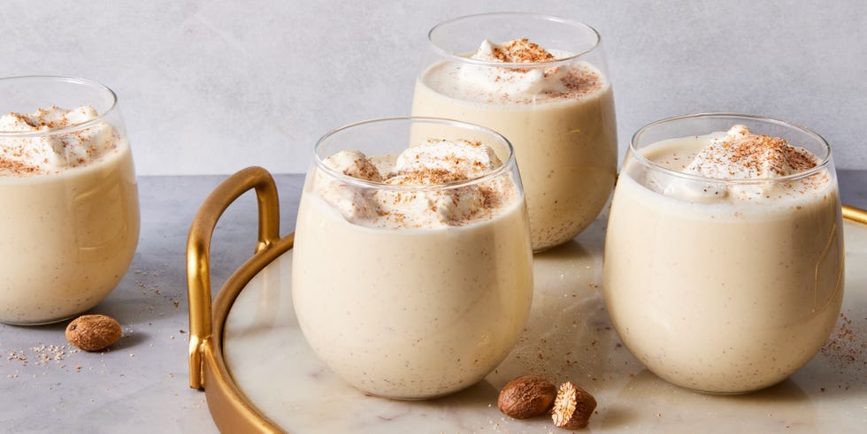 homemade eggnog topped with whipped cream and grated nutmeg