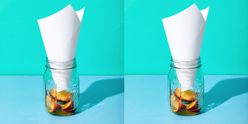 homemade fly trap, mason jar with rolled paper inside and old fruit