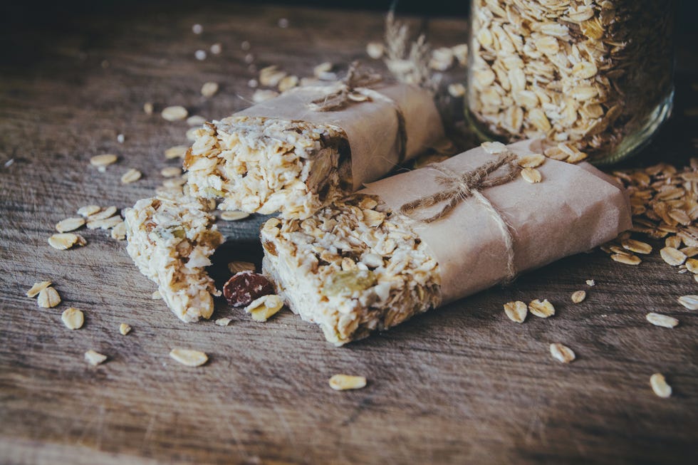 homemade granola with nut mix in jar on wooden board on stone table background healthy food