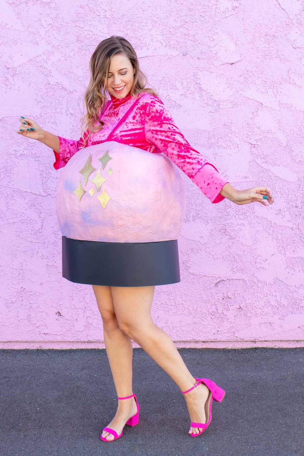 homemade halloween costumes, woman wearing a pink top, pink heels and a diy crystal ball costume