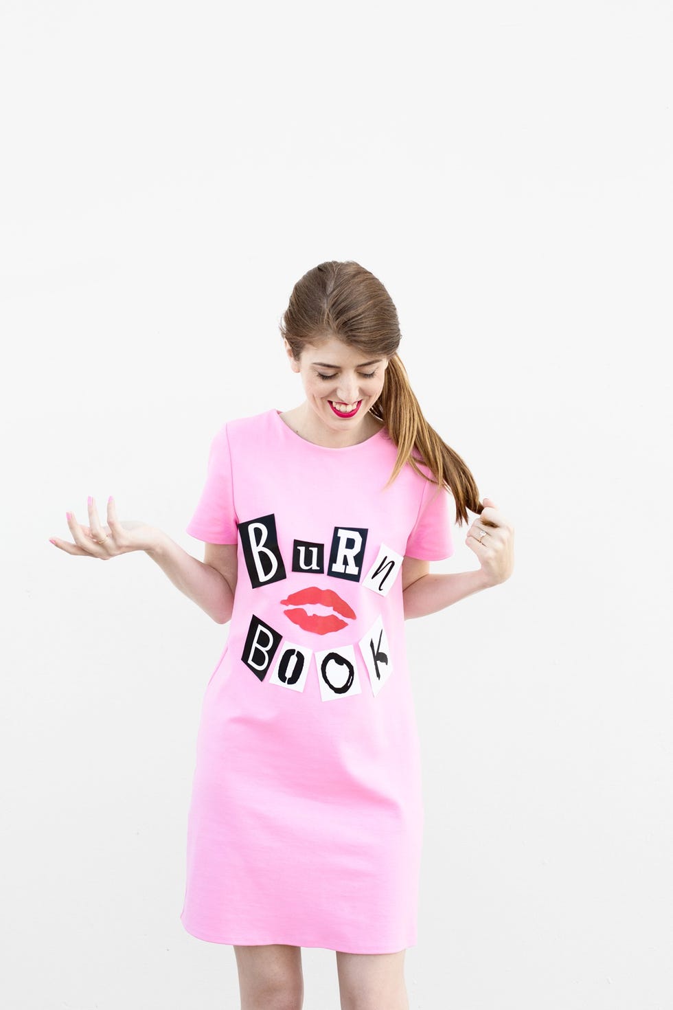 homemade halloween costumes, woman wearing a pink dress that reads burn book
