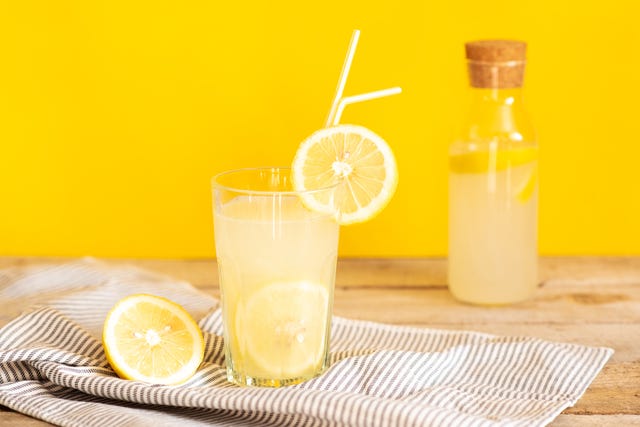 homemade lemonade in mason jars with big green paper straw