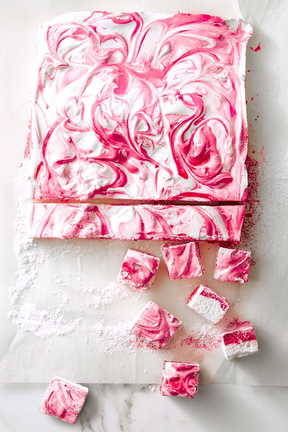 pink homemade marshmallows on parchment paper
