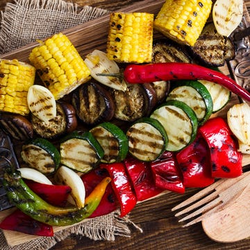 Homemade organic grilled summer vegetables on rustic table viewed from above