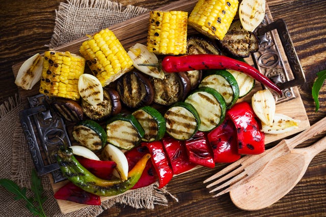 Homemade organic grilled summer vegetables on rustic table viewed from above