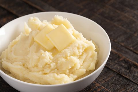 homestyle mashed potatoes with butter on a wooden table