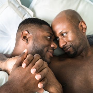 homosexual couple relaxing togetherness on the bed