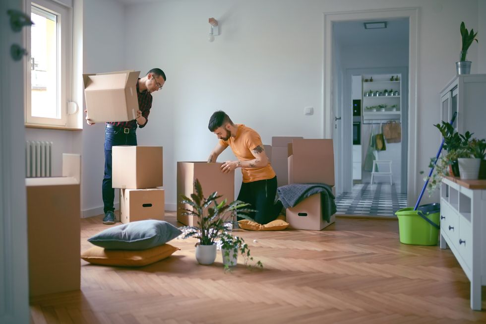 homosexual couple unpacking boxes in a new home