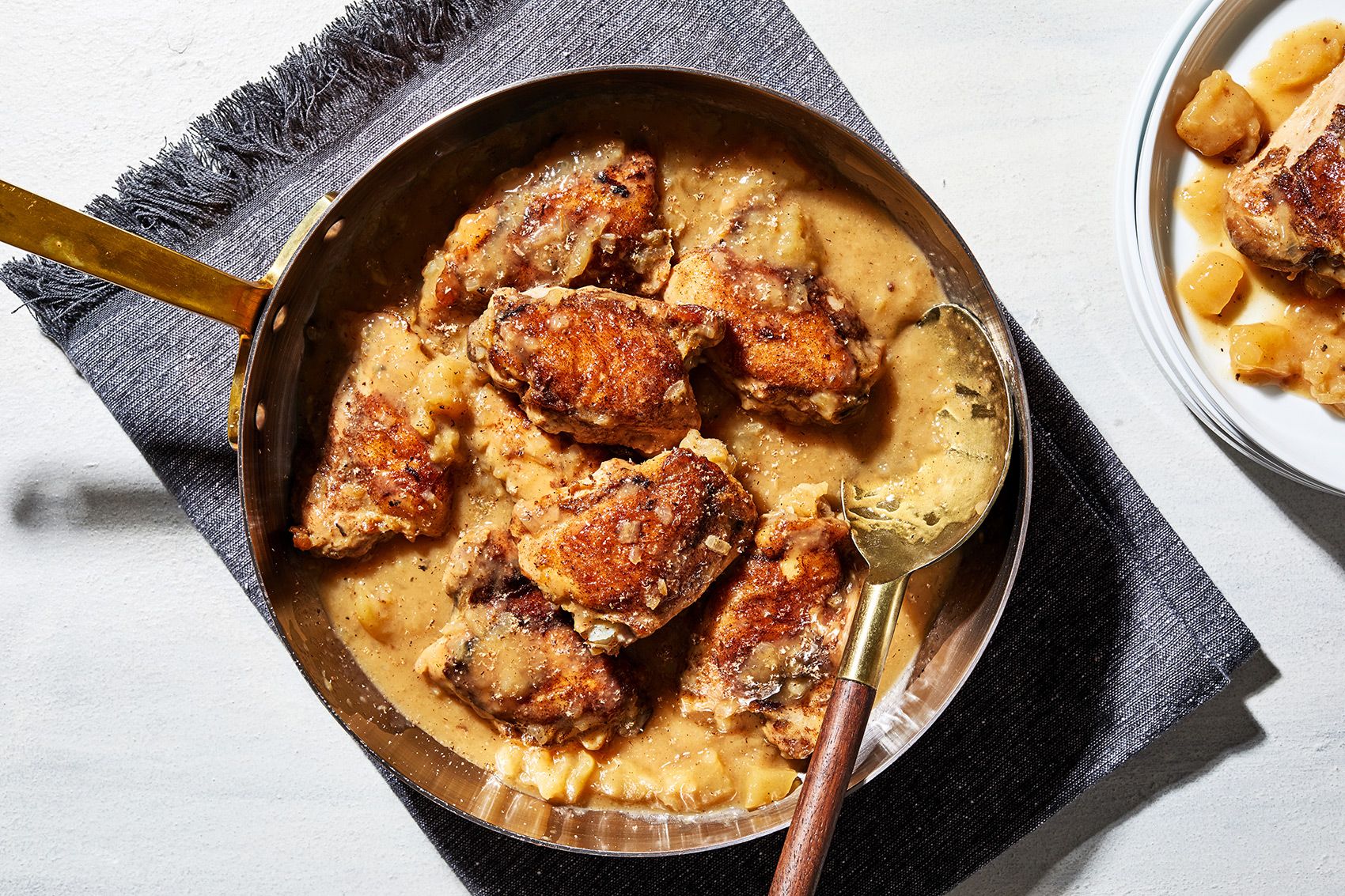 https://hips.hearstapps.com/hmg-prod/images/honey-braised-chicken-thighs-with-apple-photographed-for-news-photo-1678114558.jpg