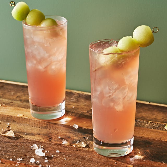 light pink honey deuce cocktail garnished with three honeydew melon balls