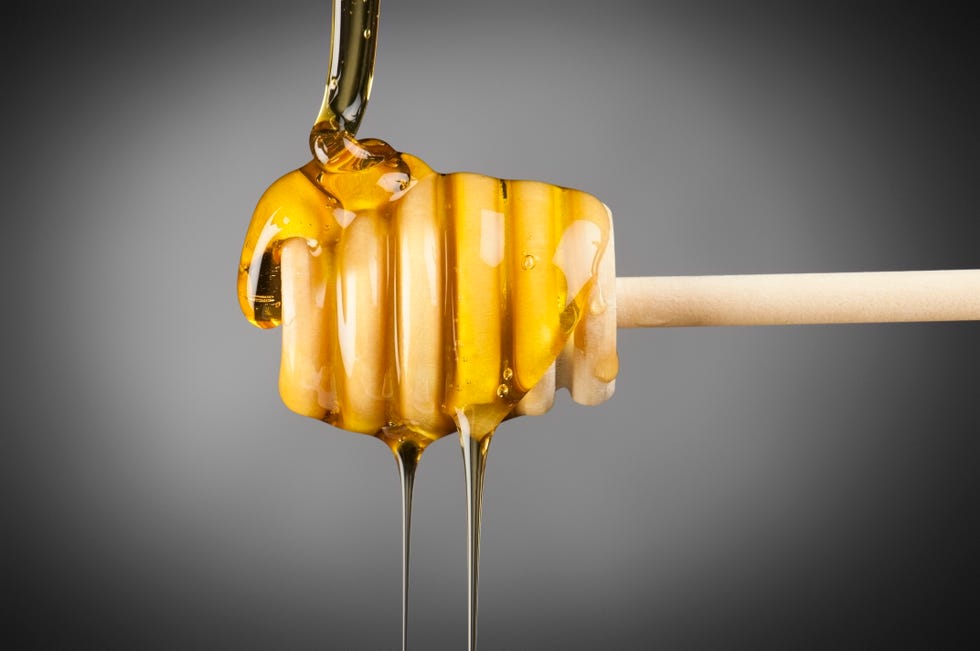 honey dripper with golden manuka honey poured over it